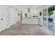 Eat-in kitchen has gray wood floors, stainless steel appliances, white cabinets, and a modern design at 750 Southland Pass, Stone Mountain, GA 30087