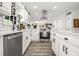 Spacious kitchen with white cabinets, stainless steel appliances, and a modern range hood at 750 Southland Pass, Stone Mountain, GA 30087