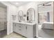 Stylishly renovated main bathroom with double vanity, modern fixtures and a walk-in closet at 750 Southland Pass, Stone Mountain, GA 30087