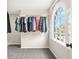 Bright walk-in closet featuring ample storage space and a large window with neighborhood views at 750 Southland Pass, Stone Mountain, GA 30087