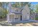 Attractive two-story home featuring a covered porch, neutral gray siding, and an attached one-car garage at 772 Edenton Ct, Jonesboro, GA 30238