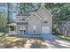 Charming two-story home with attached garage and inviting front porch; neutral siding blends with wooded surroundings at 772 Edenton Ct, Jonesboro, GA 30238