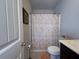 Bathroom features a patterned shower curtain, toilet, and dark sink at 2333 Castle Keep Way, Atlanta, GA 30316