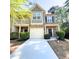Charming townhome featuring a two-car garage, brick accents, and a cozy front porch at 2333 Castle Keep Way, Atlanta, GA 30316