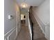Inviting hallway with staircase and neutral color palette, leading to a well-lit area at 2333 Castle Keep Way, Atlanta, GA 30316