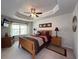 Main bedroom features a tray ceiling, ceiling fan, natural light, and carpet at 2333 Castle Keep Way, Atlanta, GA 30316