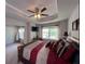 Main bedroom features a tray ceiling, ceiling fan, and natural light at 2333 Castle Keep Way, Atlanta, GA 30316