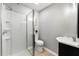 Bathroom with a walk-in shower, modern vanity, and neutral tile flooring at 2461 Antwerp Se Dr, Atlanta, GA 30315