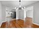 Light-filled dining room featuring hardwood floors, modern light fixture, and view to kitchen at 2461 Antwerp Se Dr, Atlanta, GA 30315
