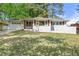 Charming one-story home featuring white painted brick, a well-manicured lawn and an attached garage at 2461 Antwerp Se Dr, Atlanta, GA 30315