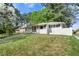 Charming one-story white brick home with a well-manicured lawn and mature trees providing shade at 2461 Antwerp Se Dr, Atlanta, GA 30315