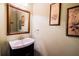 Elegant powder room features a stylish vanity with a framed mirror and tasteful wall art at 2928 Wintercrest Way, Atlanta, GA 30360