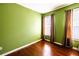 Bedroom with hardwood floors, green walls, and natural light from the window at 2928 Wintercrest Way, Atlanta, GA 30360