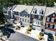 Charming townhomes with brick and siding exteriors, manicured lawns, and attached garages on a sunny day at 2928 Wintercrest Way, Atlanta, GA 30360