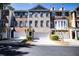 A brick townhome featuring a two-car garage and neutral paint at 2928 Wintercrest Way, Atlanta, GA 30360