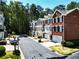 View of brick townhomes on a tree-lined street at 2928 Wintercrest Way, Atlanta, GA 30360
