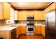 Kitchen featuring stainless steel appliances, light wood cabinets, and mosaic backsplash at 2928 Wintercrest Way, Atlanta, GA 30360