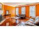Living room with hardwood floors, fireplace, orange walls, and ample natural light at 2928 Wintercrest Way, Atlanta, GA 30360