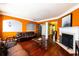 Open-concept living room with a fireplace, hardwood floors, and connected dining area at 2928 Wintercrest Way, Atlanta, GA 30360