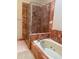 Bathroom with a marble tiled shower and bathtub at 4487 Park Place Ter, Marietta, GA 30066
