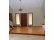 Open entryway with hardwood floors, a front door, and two windows with woven shades at 4487 Park Place Ter, Marietta, GA 30066