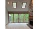 Sun-filled living room features stone fireplace, skylights, and walls of large windows at 4487 Park Place Ter, Marietta, GA 30066