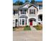 Charming townhome featuring a red front door, bay window, and well-maintained landscaping at 73 Timber Ridge Dr, Cartersville, GA 30121