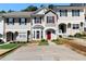 Charming townhome featuring a red front door, bay window, and well-maintained landscaping at 73 Timber Ridge Dr, Cartersville, GA 30121