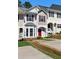 Charming townhome featuring a red front door, bay window, and well-maintained landscaping at 73 Timber Ridge Dr, Cartersville, GA 30121