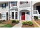 Charming townhome featuring a red front door, bay window, and well-maintained landscaping at 73 Timber Ridge Dr, Cartersville, GA 30121