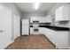 Functional kitchen featuring white cabinets, black countertops, and essential appliances at 73 Timber Ridge Dr, Cartersville, GA 30121
