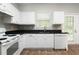 Efficient kitchen setup featuring essential appliances, ample counter space, and a view of the outdoors at 73 Timber Ridge Dr, Cartersville, GA 30121