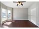 Bright living room featuring hardwood floors, a ceiling fan, and large windows at 73 Timber Ridge Dr, Cartersville, GA 30121
