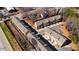 Aerial view showing multiple townhomes, parking, and green spaces at 1110 Bakary Ct, Decatur, GA 30032