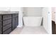 Modern bathroom featuring a freestanding tub, grey cabinets, and tile flooring at 1110 Bakary Ct, Decatur, GA 30032