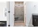 Bathroom with a glass-enclosed shower with built-in seat and dark wood cabinets at 1110 Bakary Ct, Decatur, GA 30032