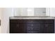Bathroom vanity with double sinks, granite countertop, and dark cabinets at 1110 Bakary Ct, Decatur, GA 30032