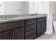 Bathroom vanity with double sinks, granite countertop, and dark cabinets at 1110 Bakary Ct, Decatur, GA 30032