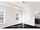 Bedroom with tray ceiling, two windows, dark wood floors, and ensuite bathroom at 1110 Bakary Ct, Decatur, GA 30032