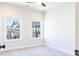 Sunlit bedroom with plush carpeting and two large windows offering neighborhood scenery at 1110 Bakary Ct, Decatur, GA 30032