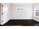 Bedroom with dark wood floors, window, and white trim throughout at 1110 Bakary Ct, Decatur, GA 30032