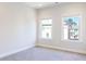 Bright bedroom with plush carpet and two windows providing natural light and neighborhood views at 1110 Bakary Ct, Decatur, GA 30032