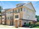 Attractive brick townhome showcasing its three-story layout and well-maintained landscaping at 1110 Bakary Ct, Decatur, GA 30032