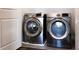Modern laundry room featuring stainless steel, front-load washer and dryer at 1110 Bakary Ct, Decatur, GA 30032