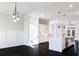 Open concept living area with black floors, custom lighting, and white walls at 1110 Bakary Ct, Decatur, GA 30032