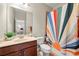 Bright bathroom with a vanity and sun-patterned shower curtain at 1647 Sabastian Ne Pt, Atlanta, GA 30329
