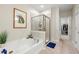 Bright bathroom featuring a walk-in shower, bath tub and walk-in closet at 1647 Sabastian Ne Pt, Atlanta, GA 30329