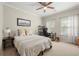 Cozy bedroom with neutral color palette, ceiling fan, desk area, and bright natural light at 1647 Sabastian Ne Pt, Atlanta, GA 30329
