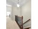 Upstairs hallway features carpet flooring, iron railing and pendant light at 1647 Sabastian Ne Pt, Atlanta, GA 30329