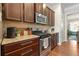 Modern kitchen with granite countertops, stainless steel appliances, and dark wood cabinetry for a sleek design at 1647 Sabastian Ne Pt, Atlanta, GA 30329